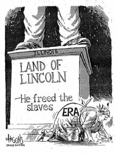 Lincoln statue that reads "Illinois / Land of Lincoln / ~He freed the slaves" with a lady cleaning the floor with the letters ERA on her dress. Higgins is the artist. 