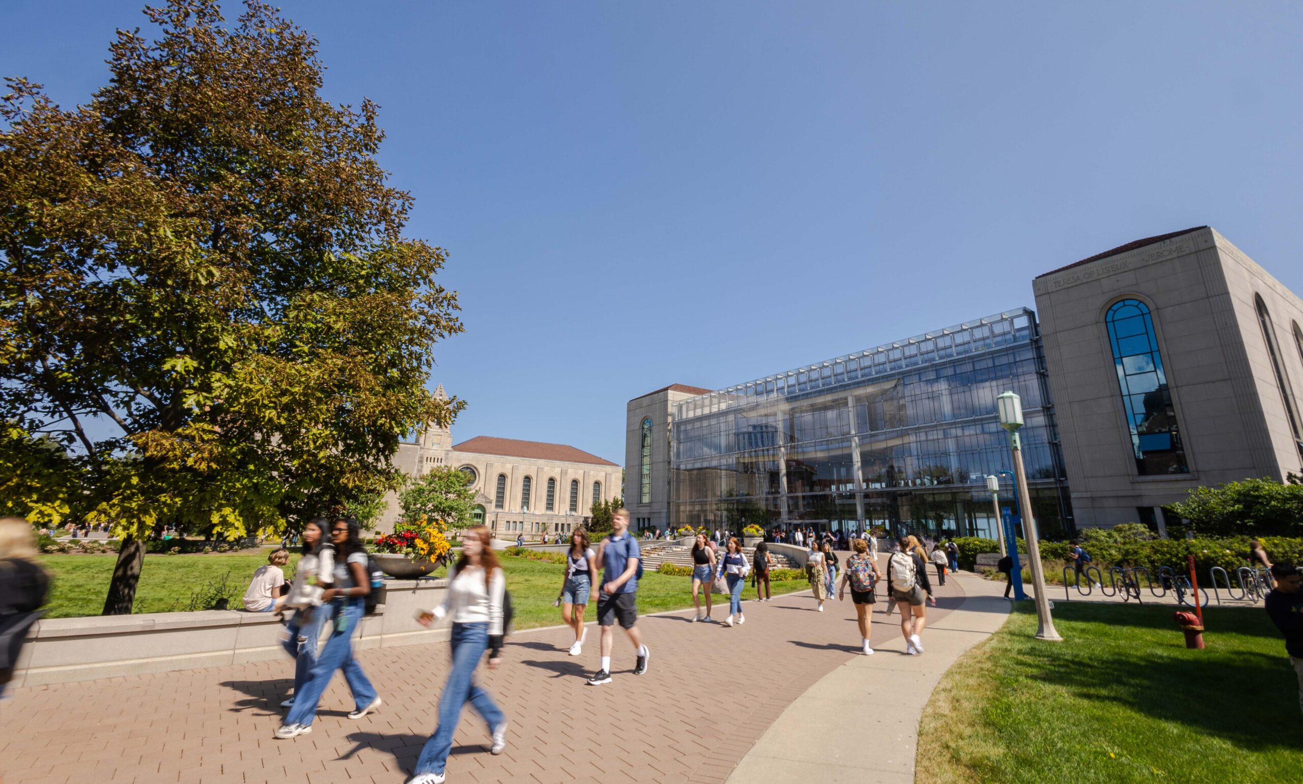 group of people walking in front of Loyola Information Commons