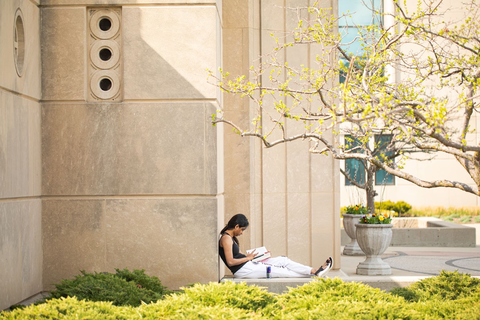 student reading in front of Madonna della Strada chapel