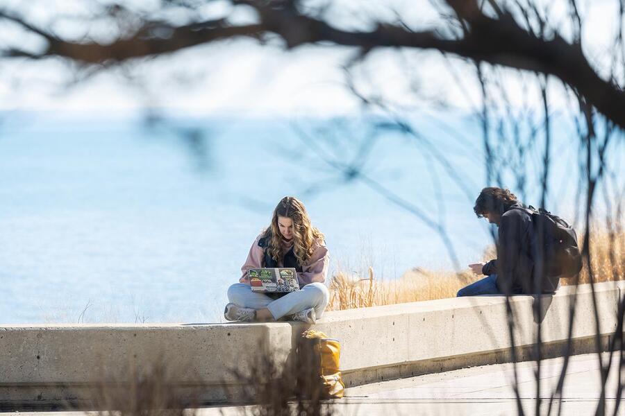 Loyola University Chicago students take advantage of sunshine and seasonably warm temperatures on February 25, 2025. (Photo: Lukas Keapproth)