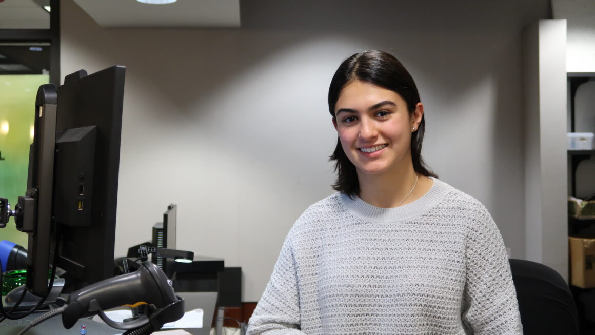 Student worker, Manuela, sits at the Lewis Library Circulation Desk