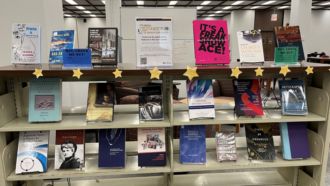 A bookshelf displaying three rows of books from the Celebration of Faculty Scholarship