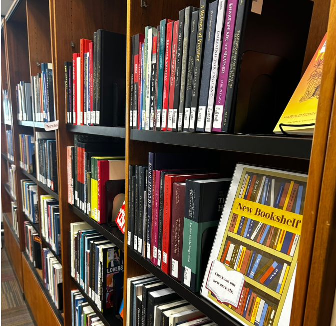 books on the shelves with a sign saying New Bookshelf