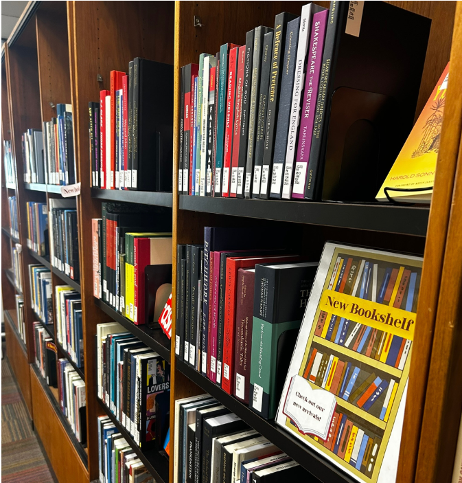 books on the shelves with a sign saying New Bookshelf