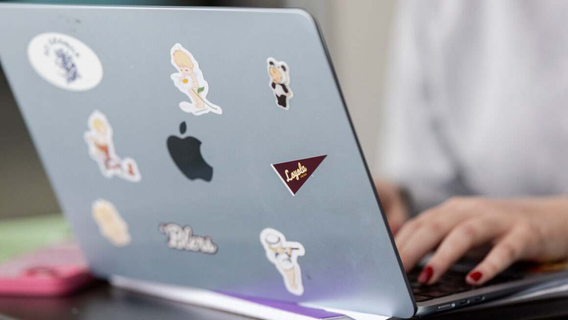a laptop with someone typing on the keyboard