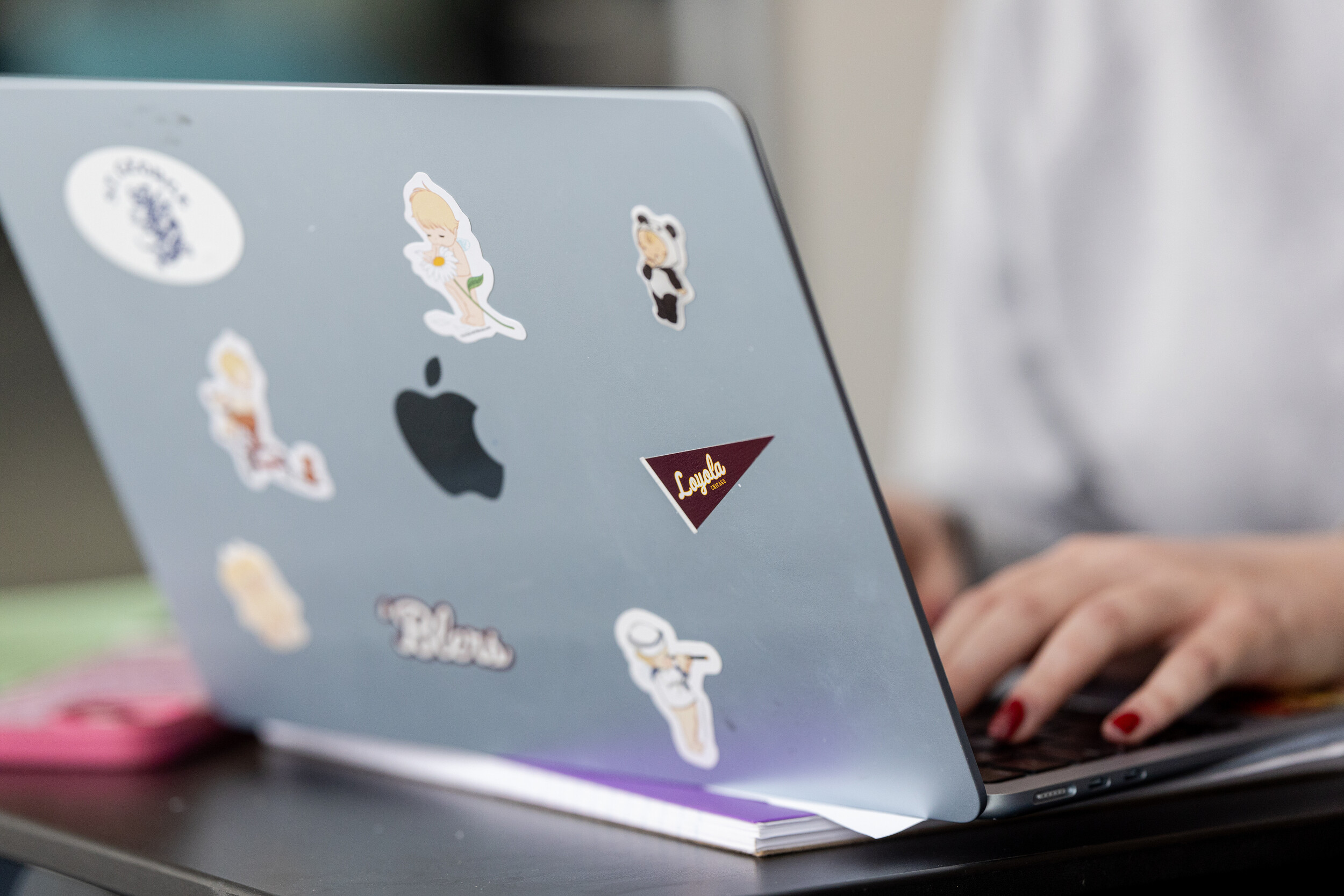 a laptop with someone typing on the keyboard